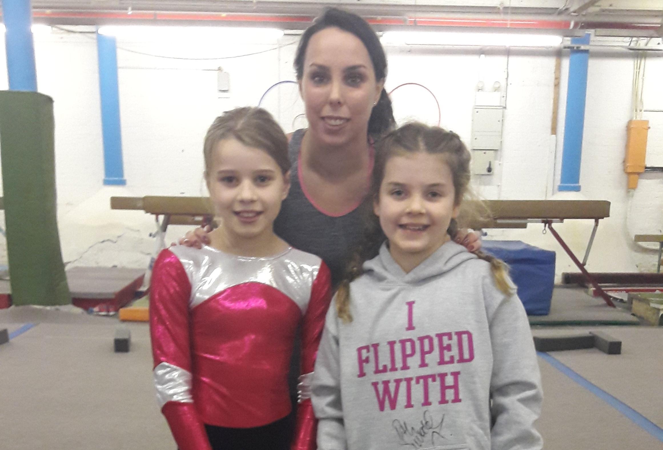 Ruby, Beth and Frankie cheadle hulme school junior pupils pose with Team GB's olympic medal-winning gymnast beth tweddle at Stockport's Vernon Park Gymnastics Club