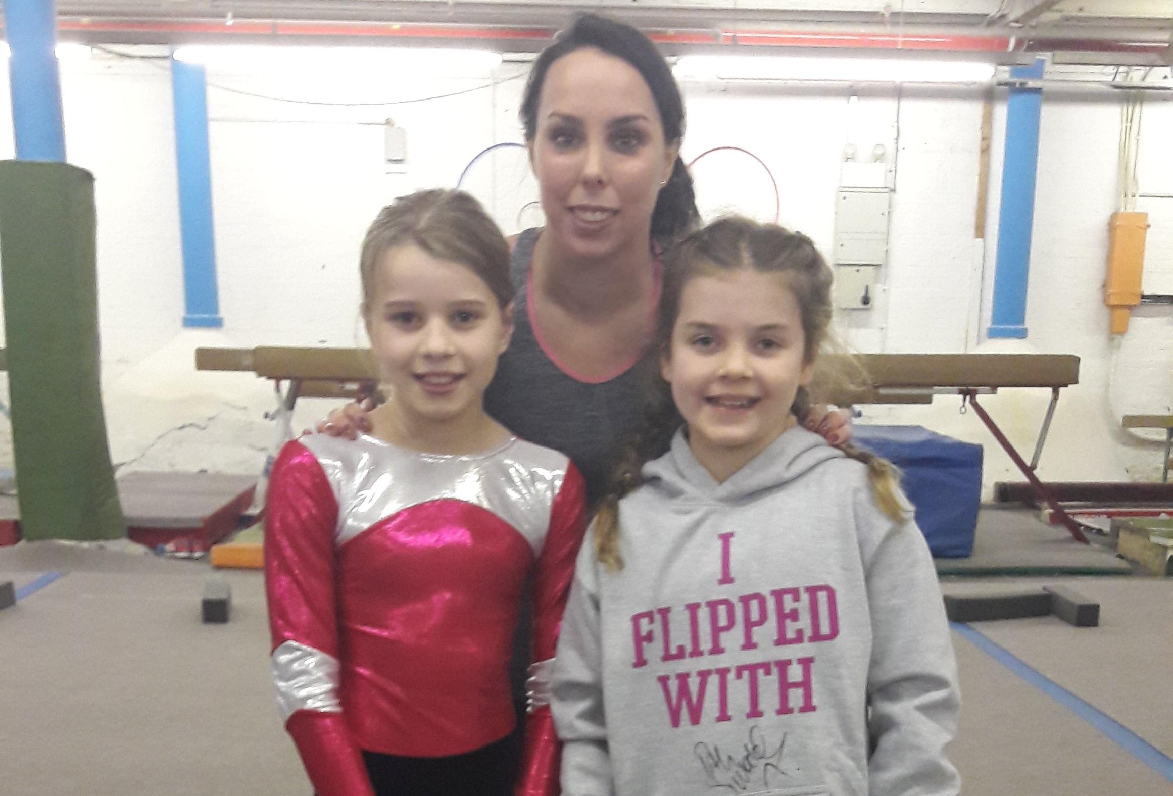 cheadle hulme school junior pupils pose with Team GB's olympic medal-winning gymnast beth tweddle at Stockport's Vernon Park Gymnastics Club 