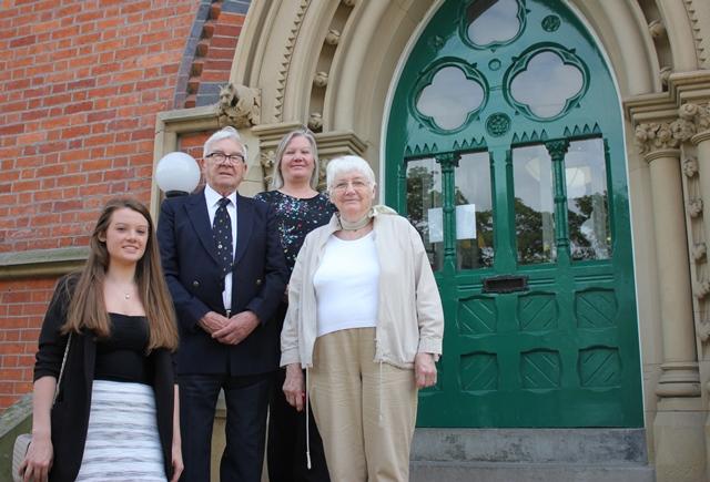 members of old waconian Arthur William' Clarke's family stand on the steps of cheadle hulme school after collecting a cheque for the alzheimer's society, the clarke house chosen charity