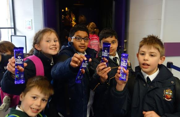 year 4 junior pupils at cheadle hulme school hold up cadbury dairy milk chocolate bars during their class trip to Cadbury world in birmingham