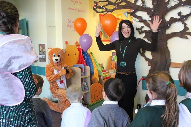 book bear and friends cut the ribbing during an opening ceremony for cheadle hulme school's new colourful infant library reading area full of books and inspirational quotes