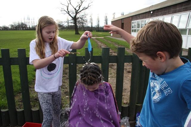 cheadle hulme school juniors and infants have fun with water balloons during the School's annual charity day whilst raising money for water aid