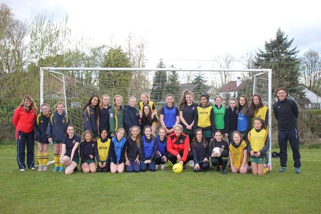 sheffield Ladies FC midfielder and first team captain Carla Ward joins the team line up has her photo taken with cheadle hulme school's squad of girls football players at a weekly training session