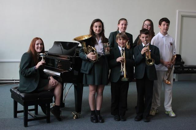 CHS's Alderley Edge Festival Musicians music students from cheadle hulme school who took part in the 100th alderley edge music festival competition gather around the piano in one of the school's music rooms