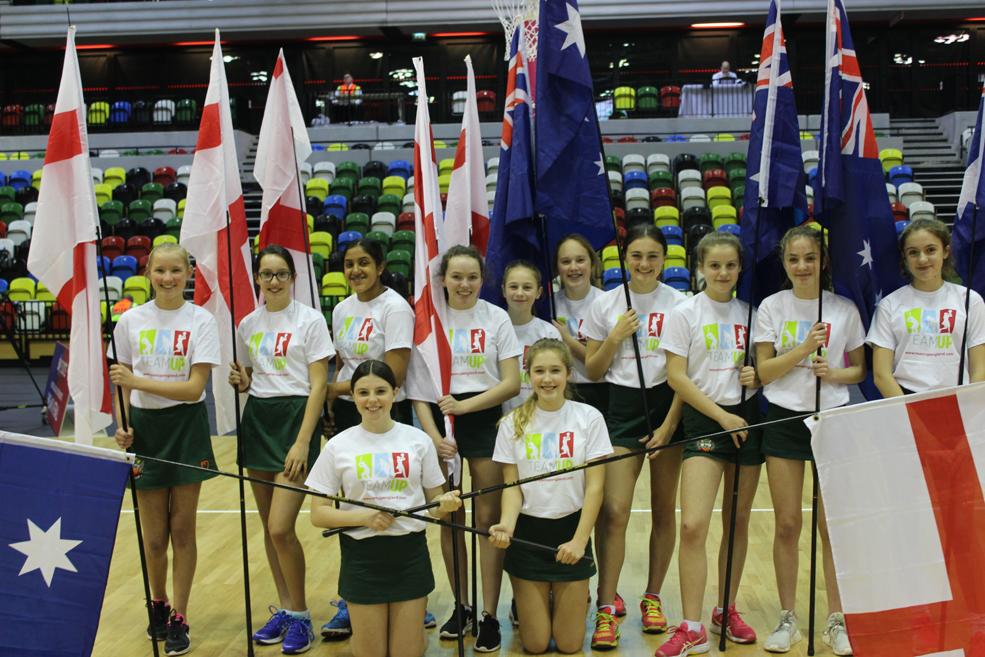 cheadle hulme school year 9 netballers stand with flags at the opening ceremony of england roses netballs vitality international quad series match 