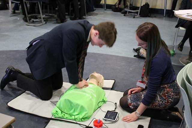 A Sixth Form student at Cheadle Hulme School practices his CPR Emergency life support skills as part of Royal Manchester Children's hospital's research project into CPR training