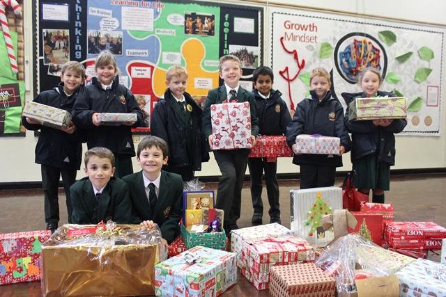 Cheadle hulme school juniors carry their Christmas box hampers to the minibus for donation to Age UK Stockport