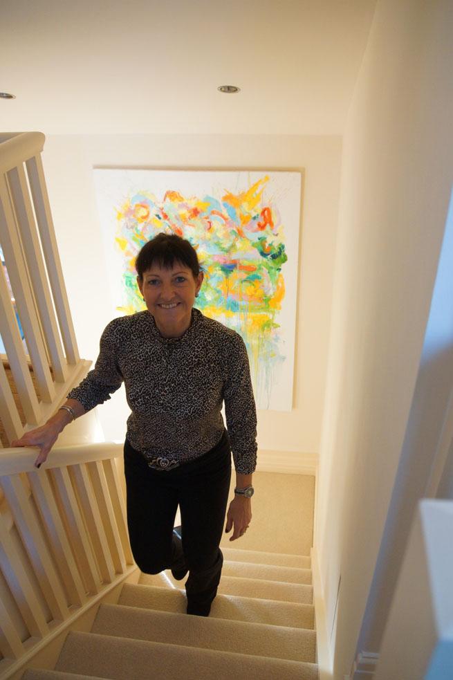 Cheadle Hulme School parent and major donor to the School's Bursary Fund, Jo Squire, proudly displays Fleur Yearsley's painting in her home