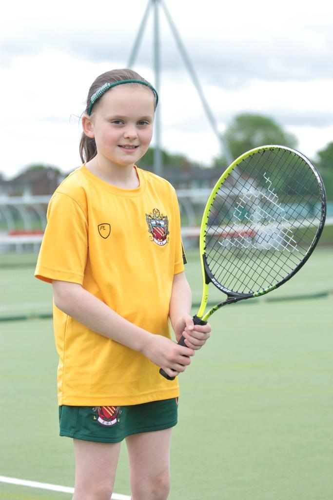 year 4 pupil leila holds her tennis racket on the astro turf courts at cheadle hulme school after being selected to represent the county in the over 10s age group at the county cup