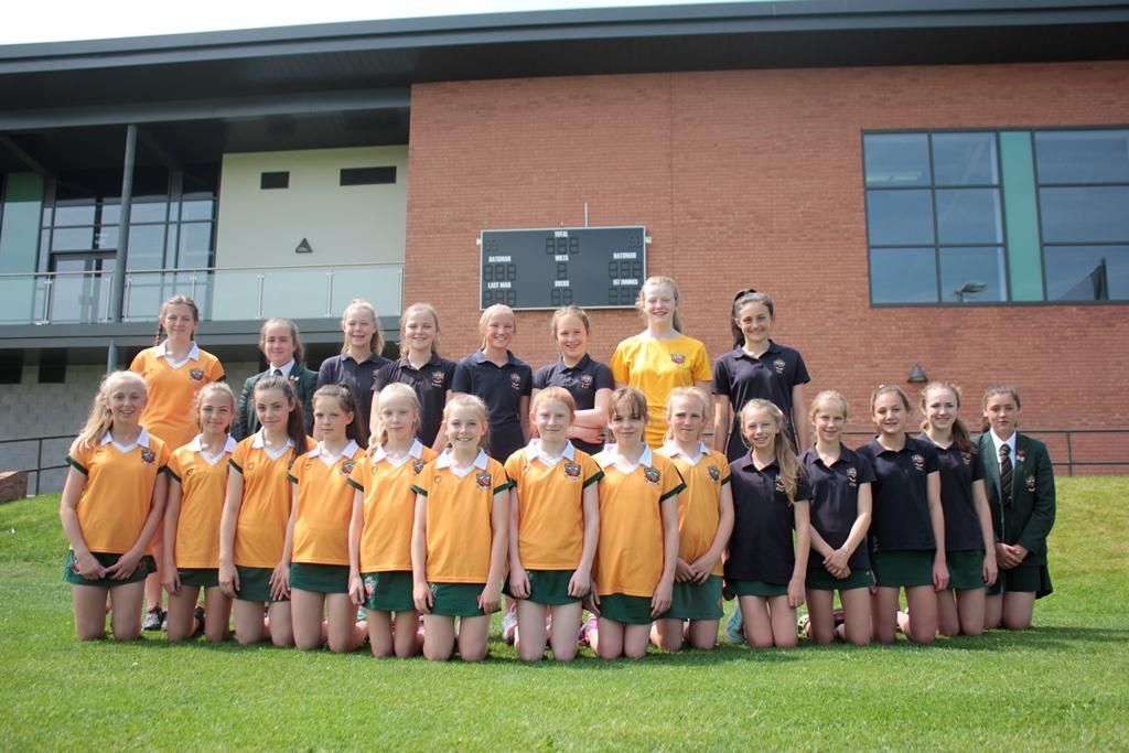 cheadle hulme school girls line up in front of the cricket board at the school pavilion and get ready to be flag-bearers in Derby for the ICC wOMENS World cup