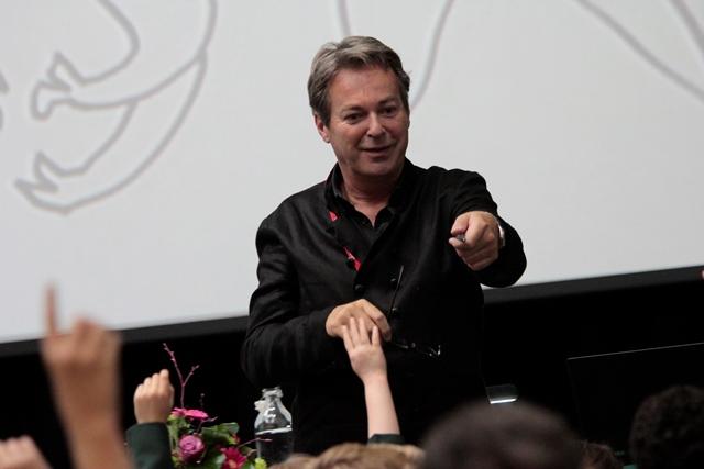 actor comedian entertainer and author Julian Clary points to students as he presents new book The Bolds On Holiday to junior pupils in Holden Hall at Cheadle Hulme School ahead of World Book Day
