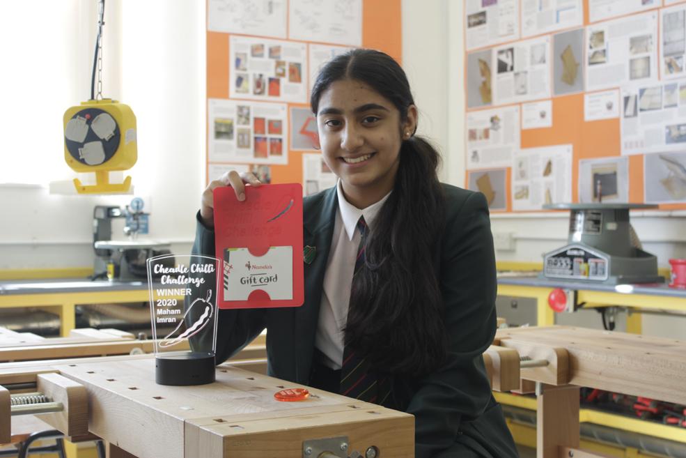 Cheadle Chilli Challenge Winner Maham in the DT Suite with her prizes design and technology student with school prizes for creativity in workshop holding voucher certificate and trophy