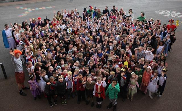 cheadle hulme school infants and juniors gather together in the School playground and wave whilst wearing their Shakespeare costumes for their annual Literature week